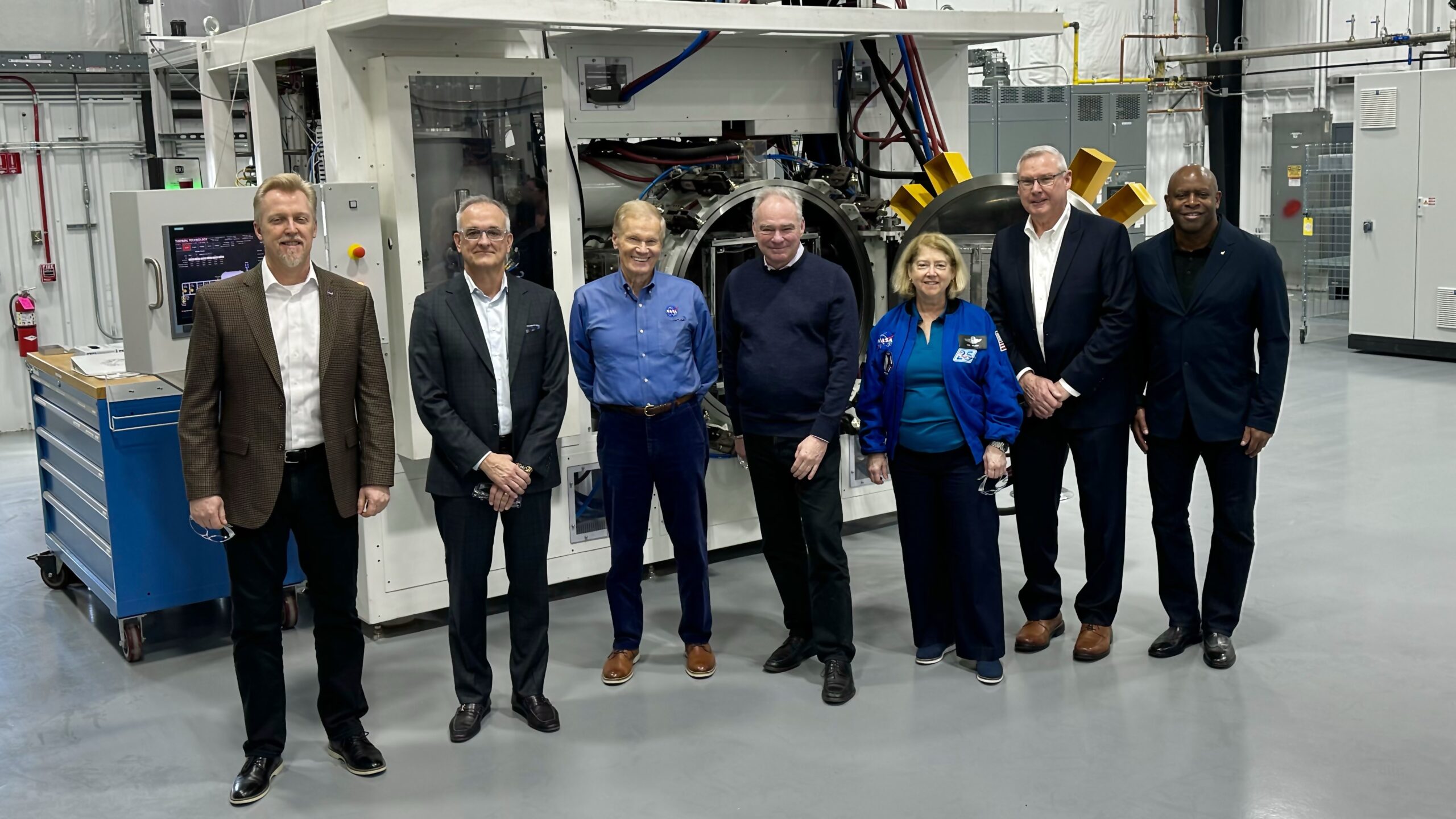 BWXT BIC executive board tour standing in front of heat furnace